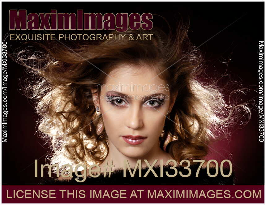 Teenage girl face with artistic makeup and flying hair