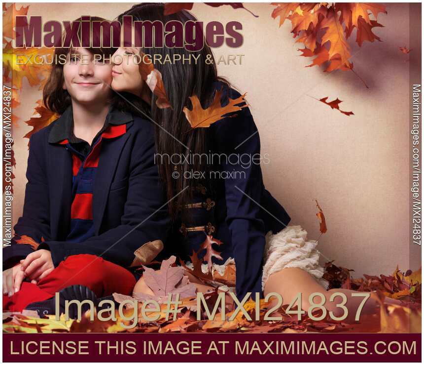 Teenage girl kissing a boy artistic fall fashion photo