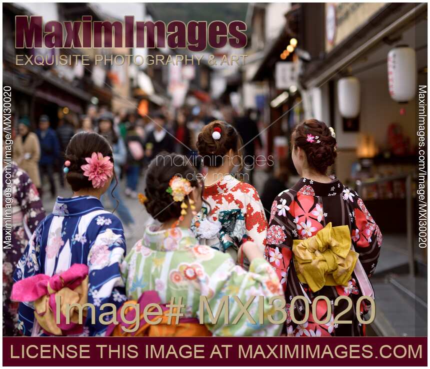 Teenage girls in colorful kimono walking on Matsubara dori street in Kyoto near Kiyomizu-dera