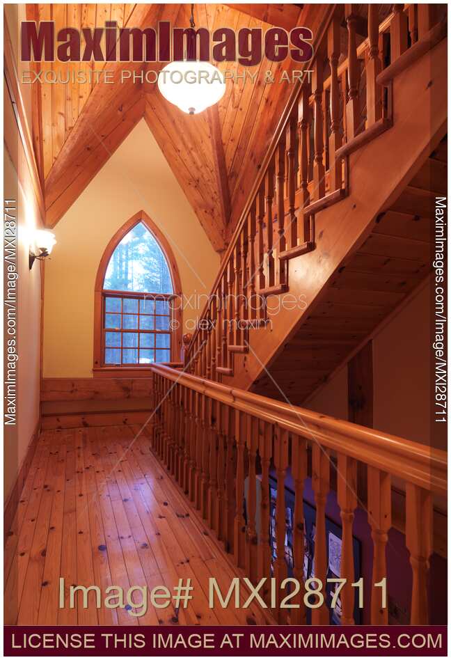 Timber frame cottage style Canadian house wooden staircase and gothic arched window