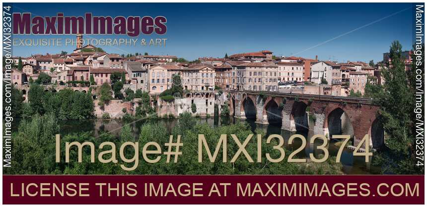 Town of Albi panorama with buildings along river Tarn and old bridge Pont Vieux South France