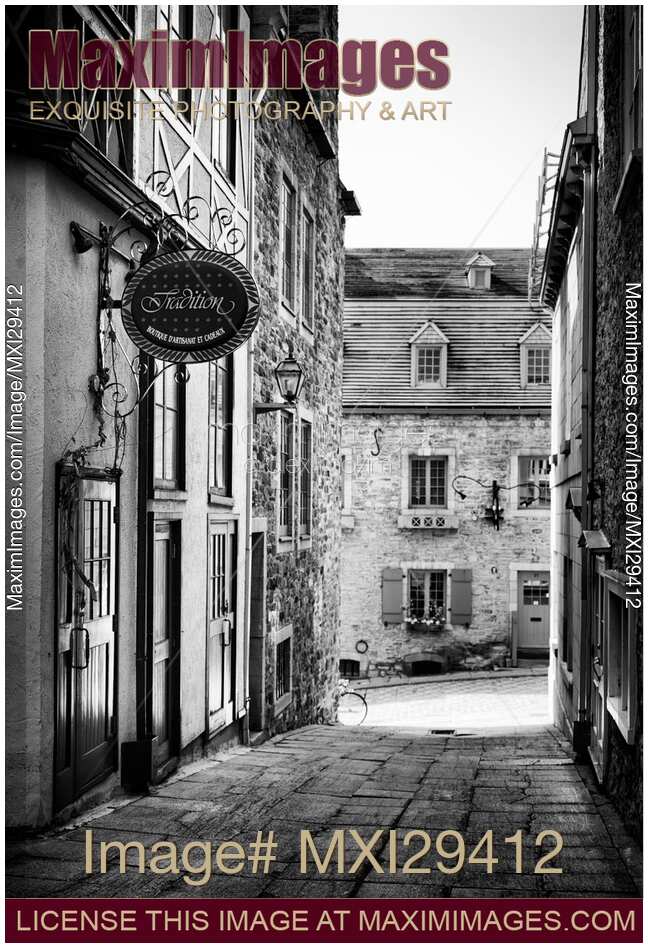Tradition boutique store sign in small historic street of Old Quebec City Black and white