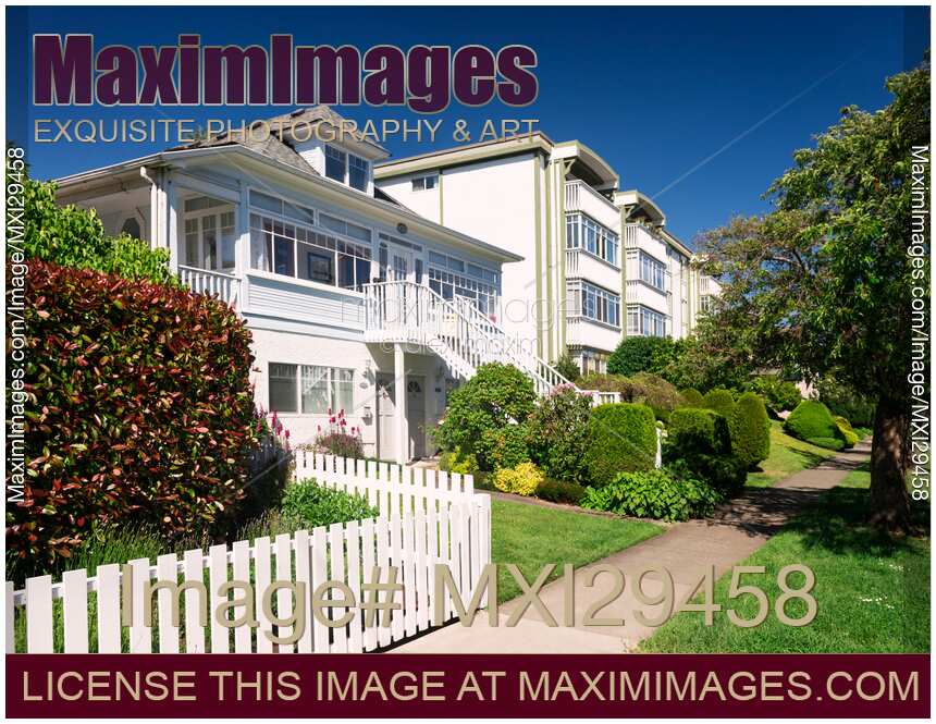 Triplex house and apartment building in Victoria BC on a summer day