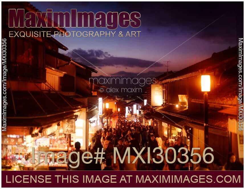 Twilight old Kyoto city scenery at Matsubara dori street in fall with brightly lit shops and street lights