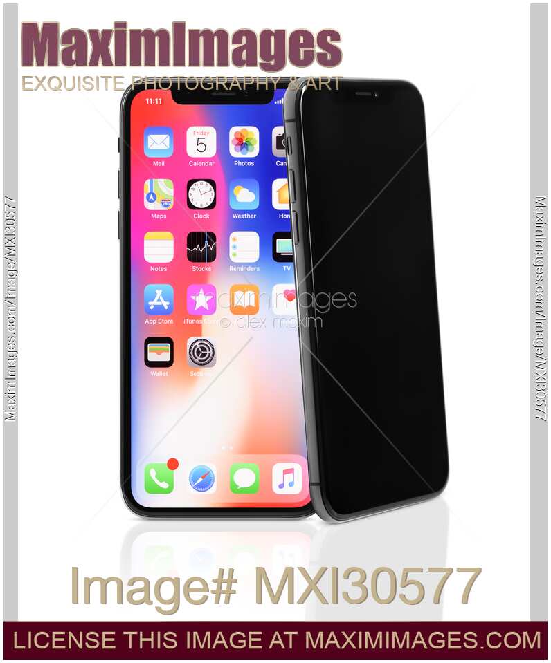 Two Apple iPhone X smartphones one leaning on another isolated on white background