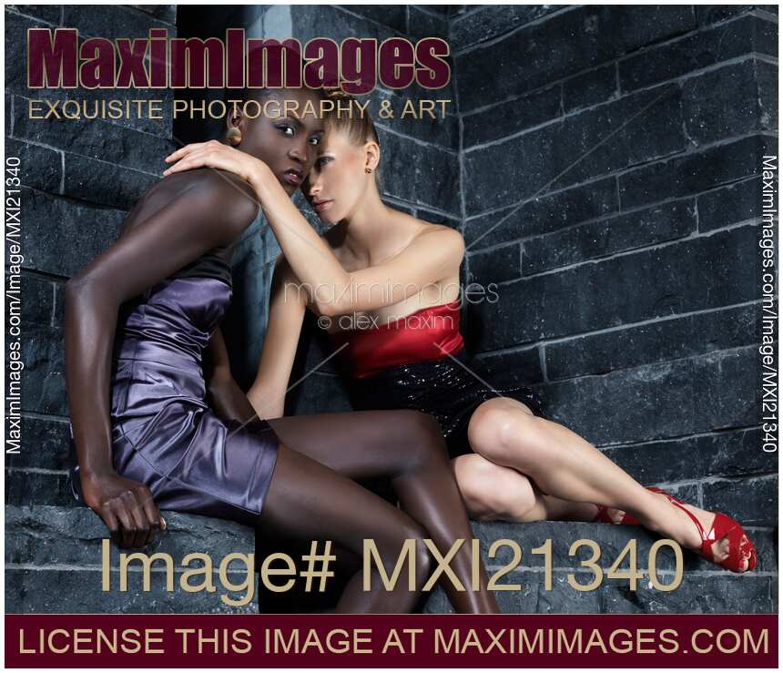 Two Beautiful Women african-american and caucasian sitting together embracing