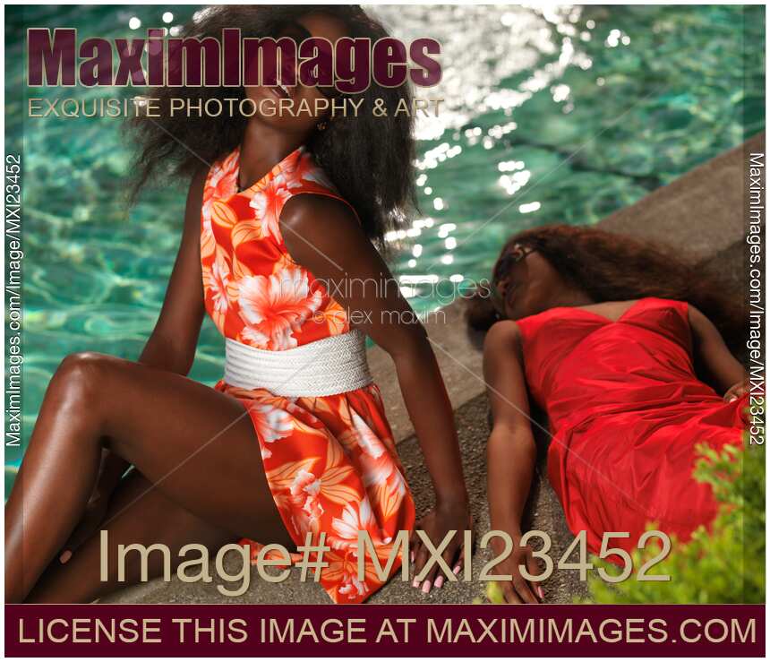 Two Beautiful Women in Dresses at the Pool