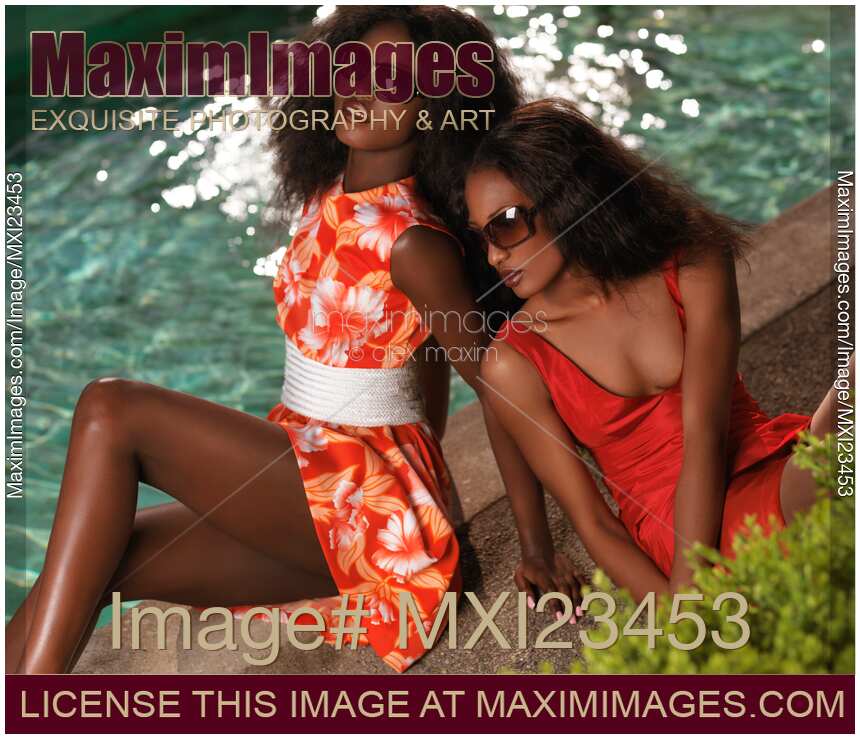 Two Beautiful Women in Dresses at the Pool