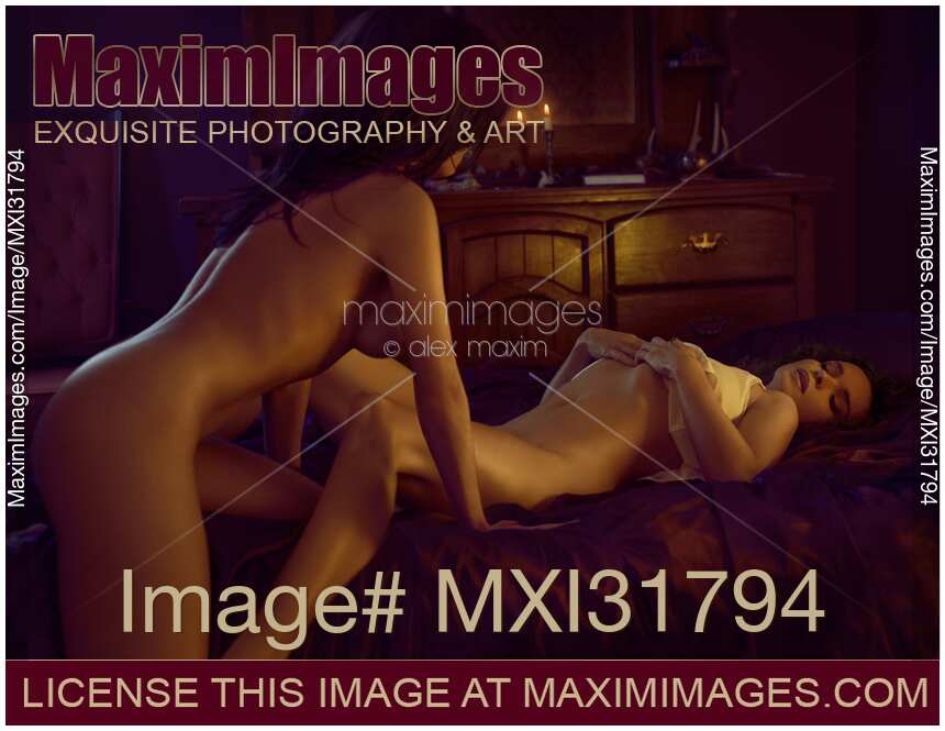 Two naked ladies in bed making love sexy romantic lesbian couple in dim candle tit bedroom