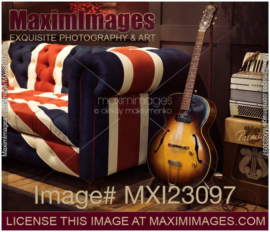 Vintage Acoustic Guitar at a Sofa