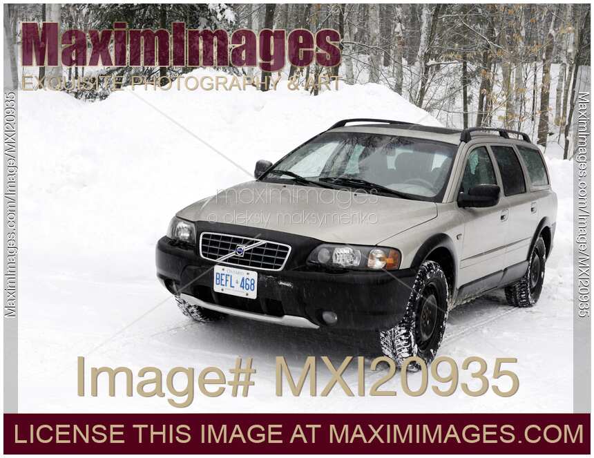 Volvo XC70 station wagon car on a snow covered road in Canada