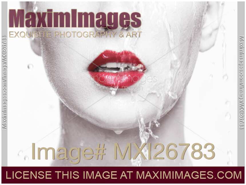 Water running over woman face closeup of lips with red lipstick