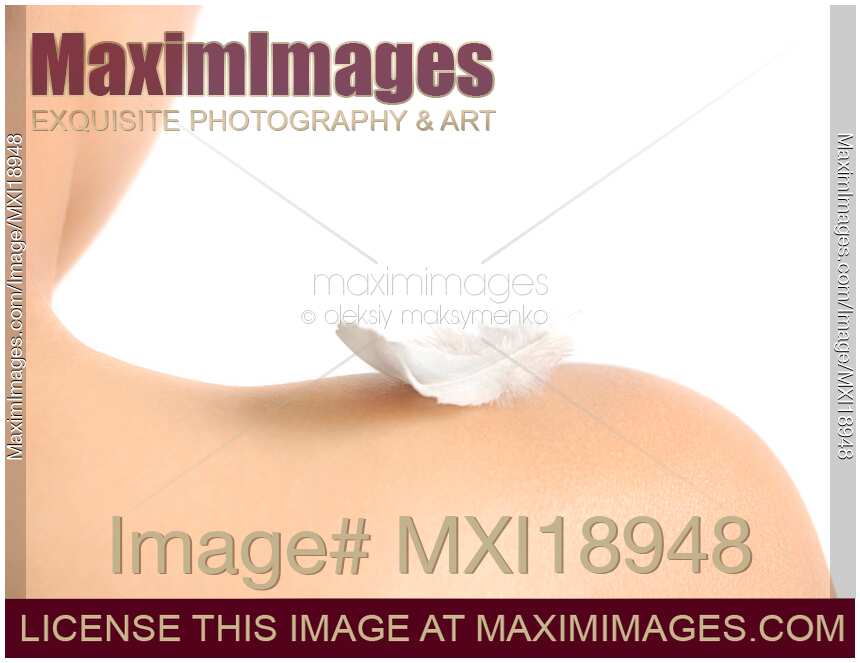 White feather on bare woman shoulder