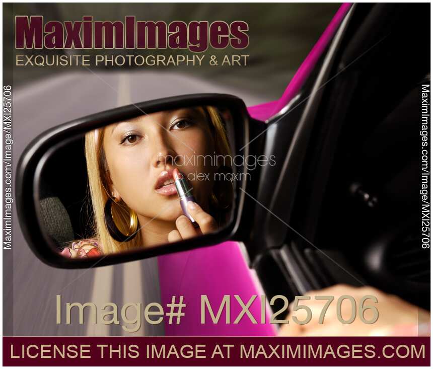 Woman Applying Lipstick in a Car