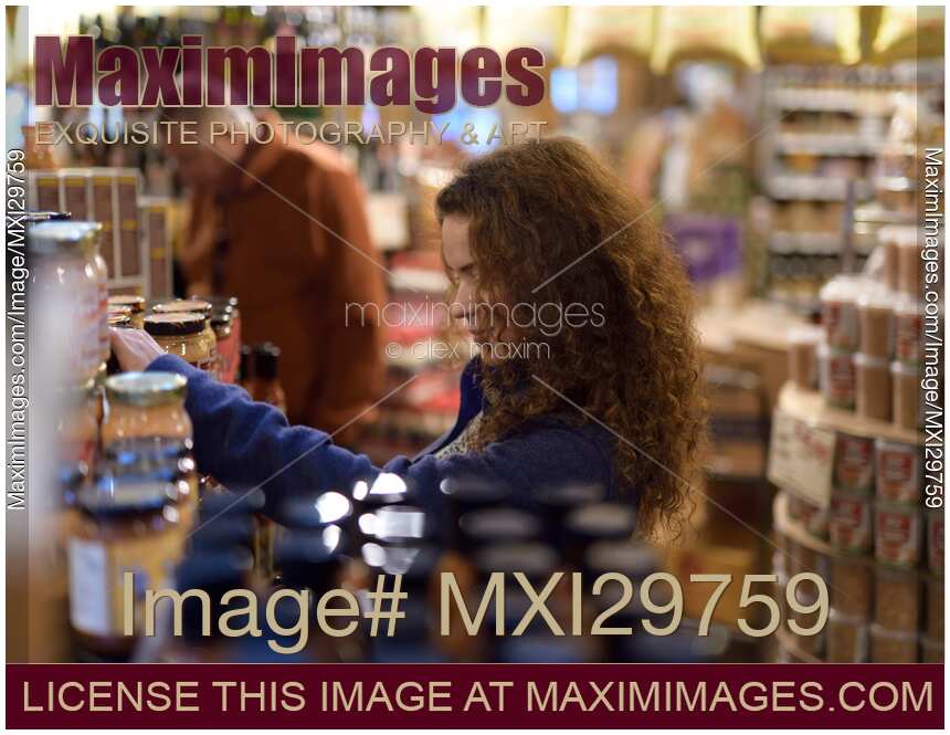 Woman at a grocery store looking at food products