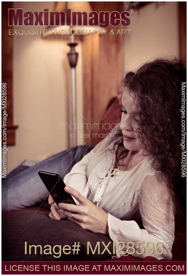 Woman at home using iPhone 7 Plus smartphone