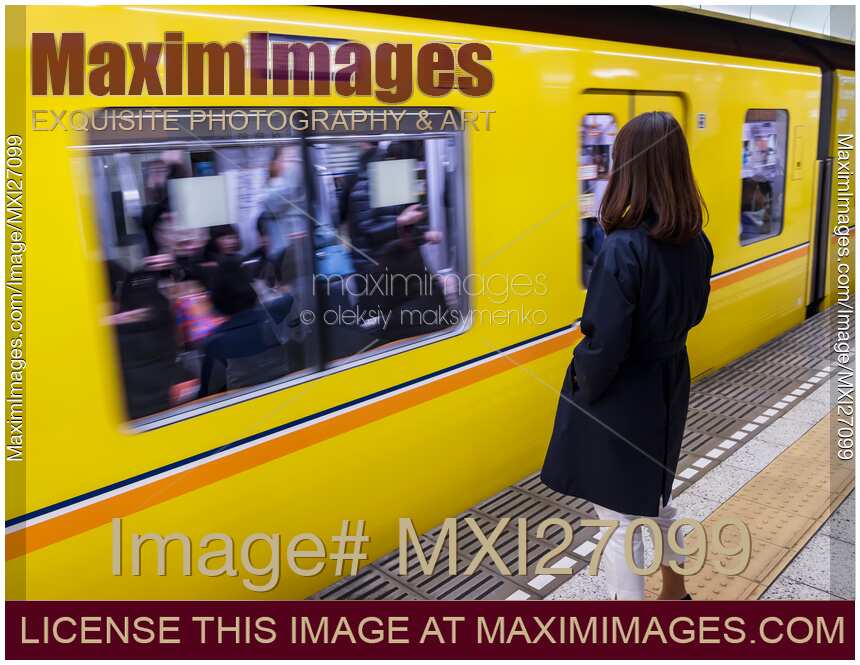 Woman at subway platform waiting for train