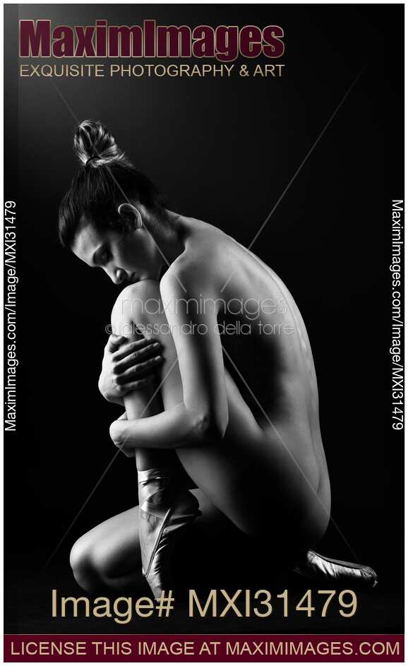 Woman ballet dancer sitting nude curled up