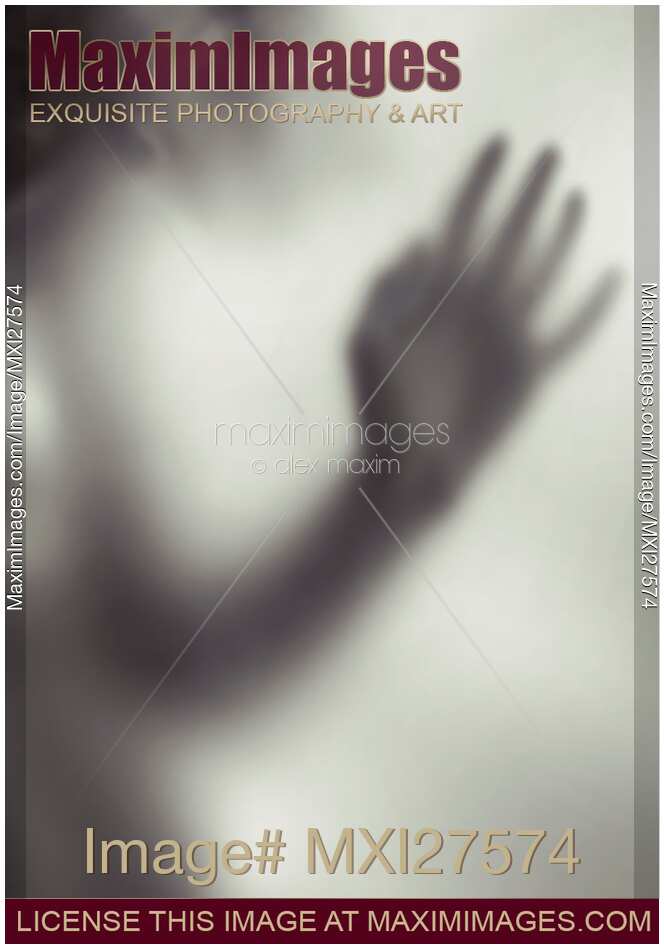 Woman blurred hand behind glass