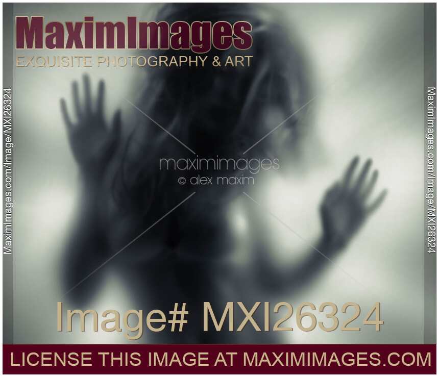 Woman blurred silhouette behind glass