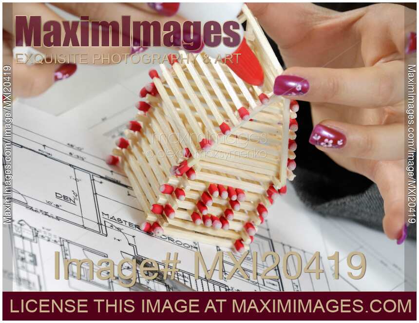 Woman Building a House from Matches