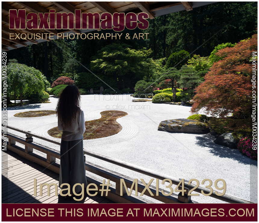 Woman contemplating Japanese Zen rock garden in Portland, Oregon