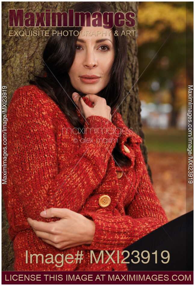 Woman Cuddling in a Sweater in Fall