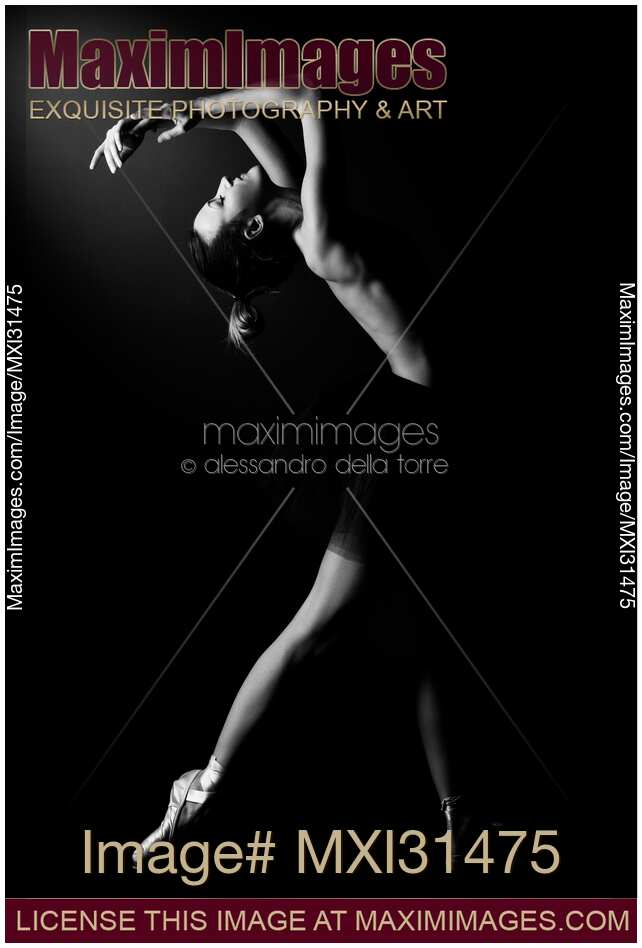 Woman dancer naked in a black tutu arching backwards