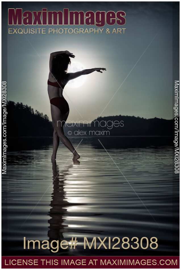 Woman dancing in moonlight under full moon on the water