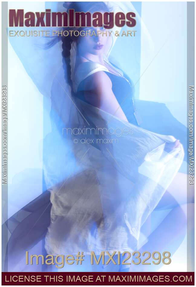 Woman dancing surrounded with blue shiny light
