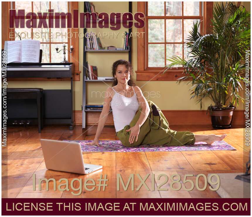 Woman doing yoga exercise on a living room floor