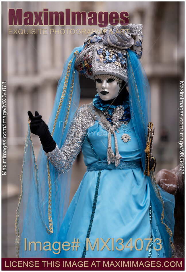 Woman dressed in blue and silver carnival costume and a mask during the Carnival of Venice Italy