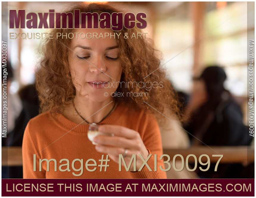 Woman drinking sake in Japanese restaurant in Kyoto
