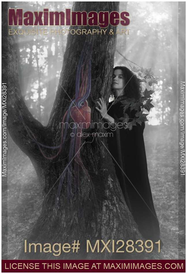 Woman druid listening to heartbeat of the tree Black and white