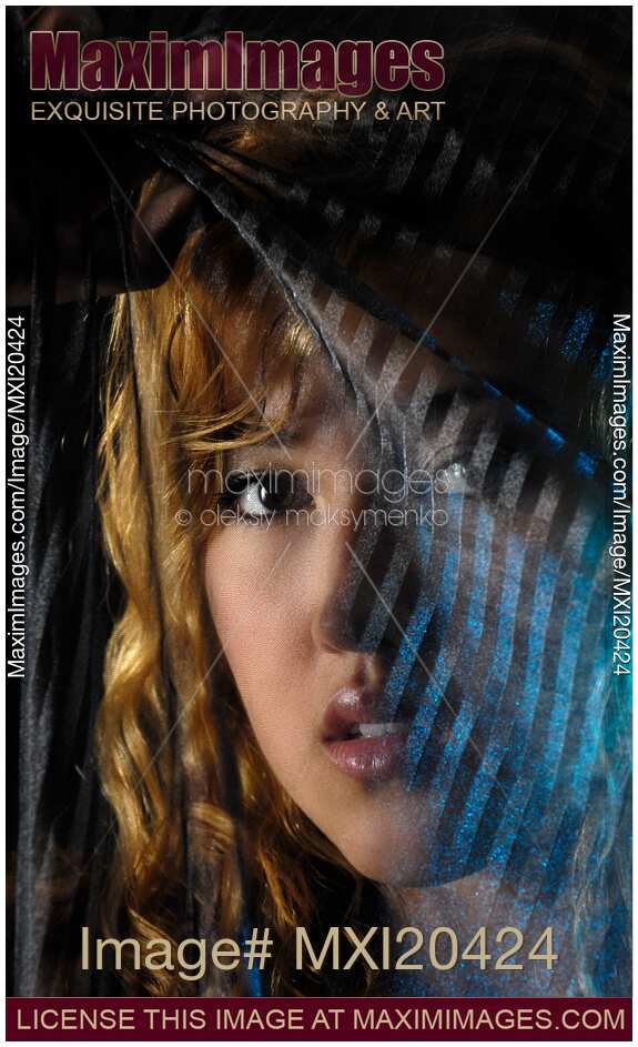 Woman face behind black curtain