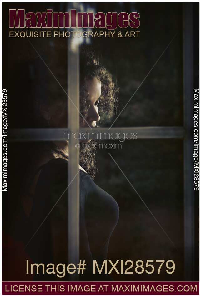 Woman face behind window glass