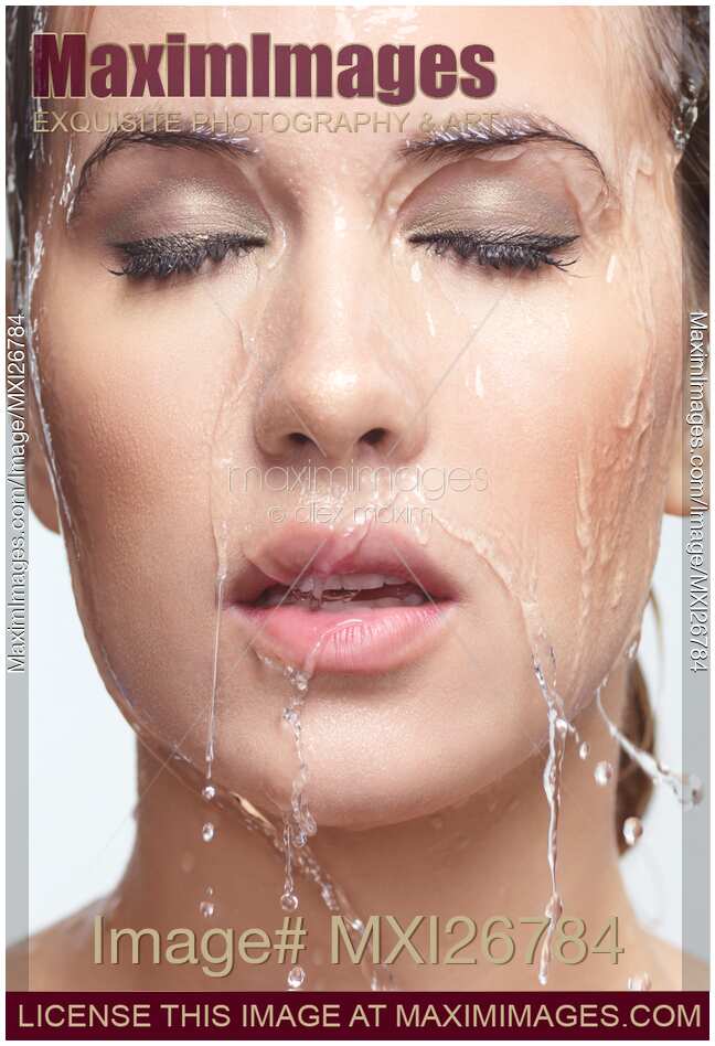 Woman face with water pouring over it