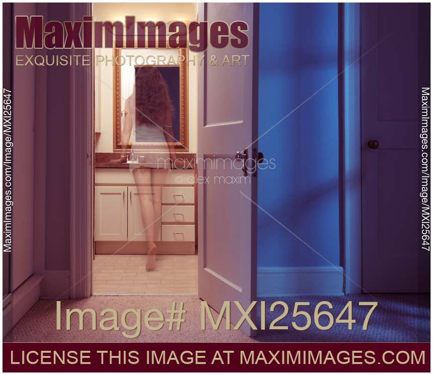 Woman ghost at a bathroom mirror