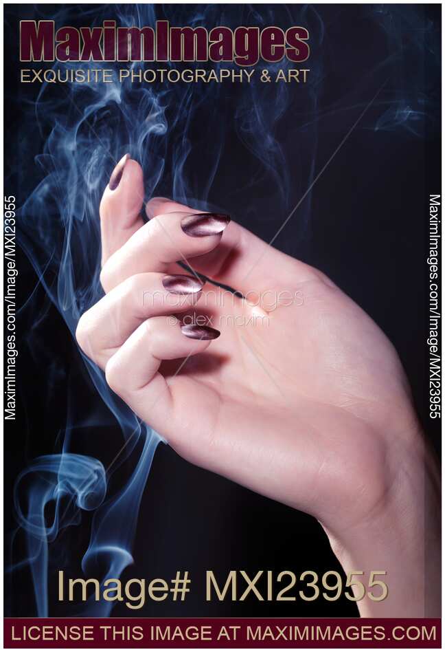 Woman Hand in a Stream of Smoke