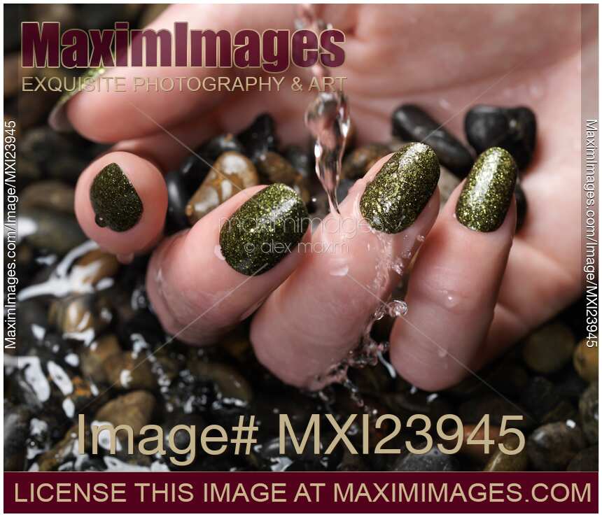 Woman Hand With Fancy Nail Polish in Water