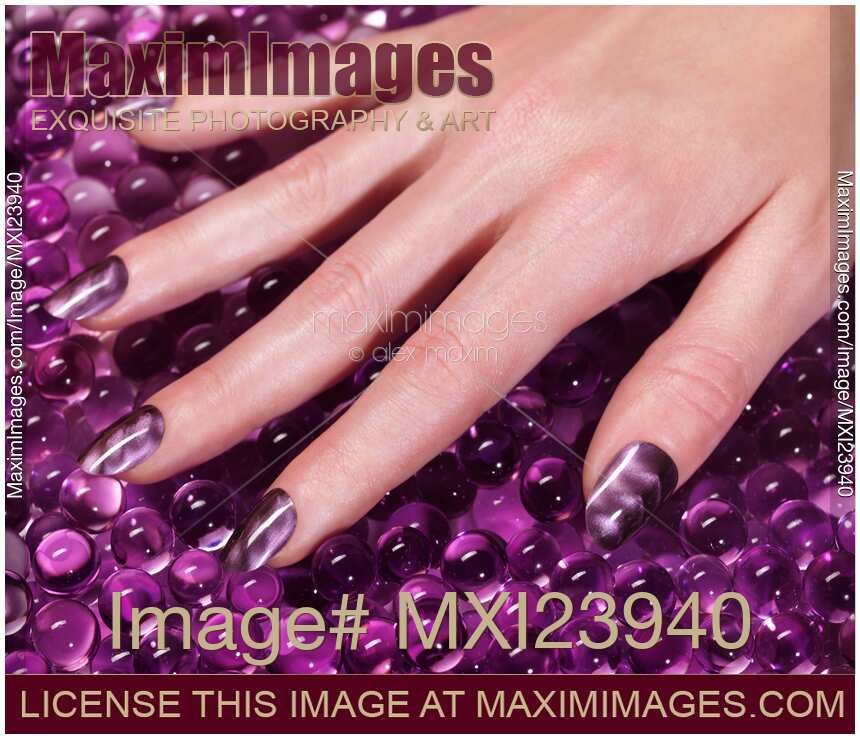 Woman Hand With Purple Nail Polish