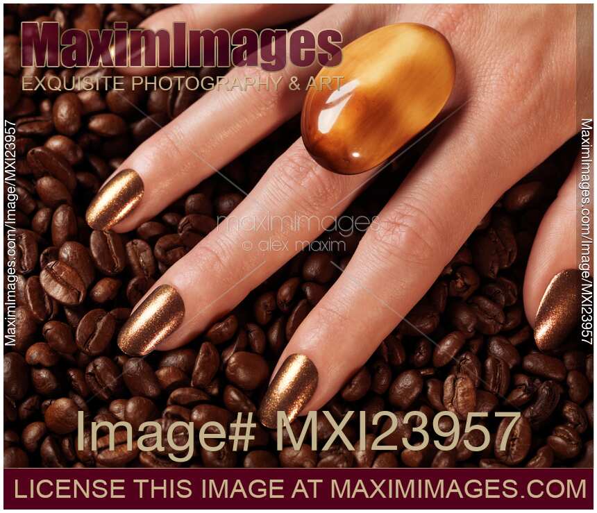 Woman Hands in Coffee Beans