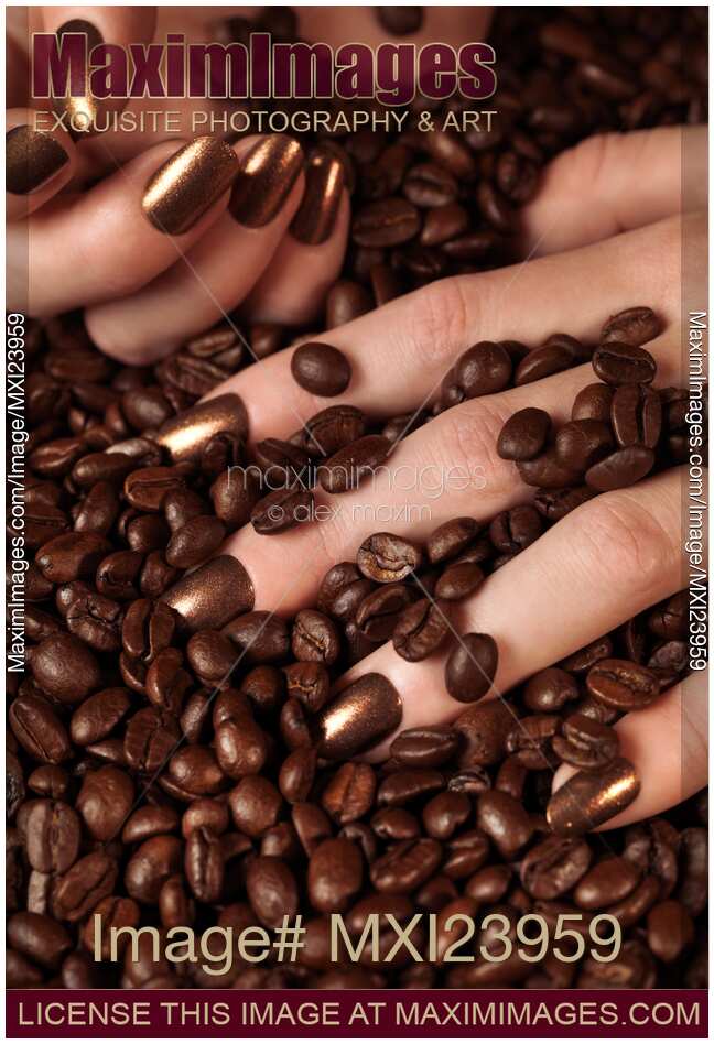 Woman Hands in Coffee Beans
