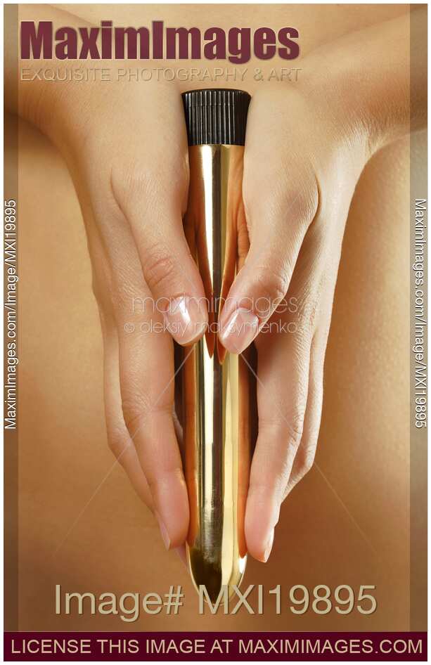 Woman Holding a Gold Vibrator