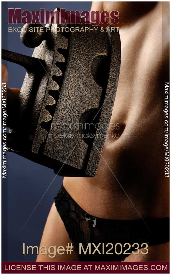 Woman holding antique flat iron in front of her stomach