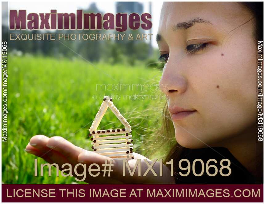 Woman holding house from matches in hand