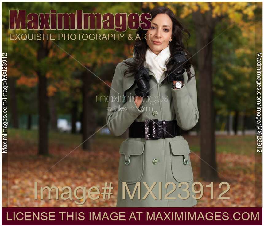 Woman in a City Park Wearing a Green Coat