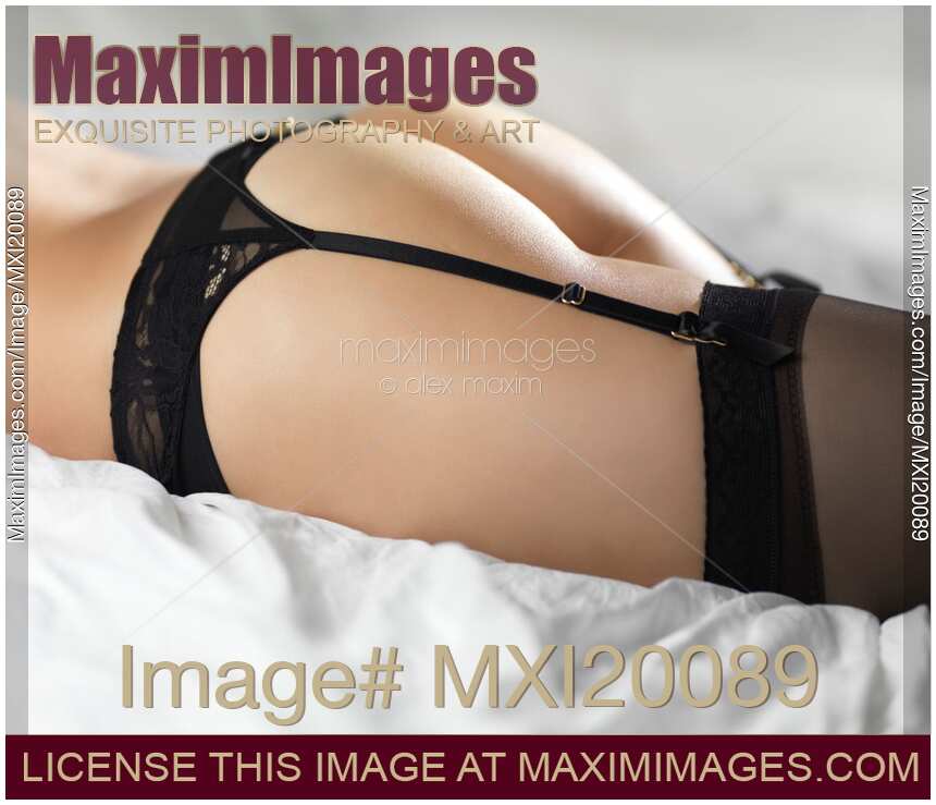 Woman in Lingerie Lying on a Bed
