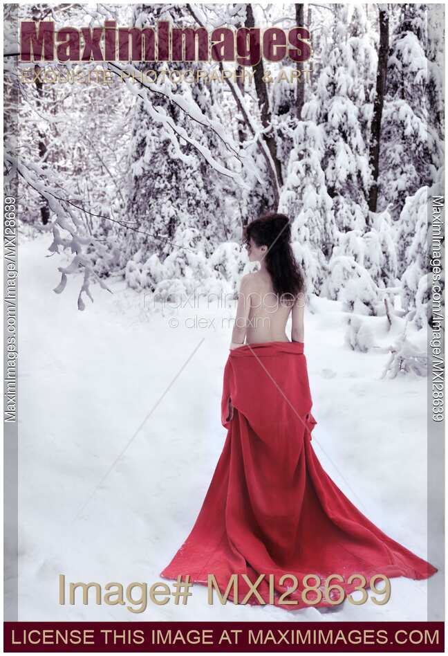 Woman in red kimono lowered down to her waist walking away in snow