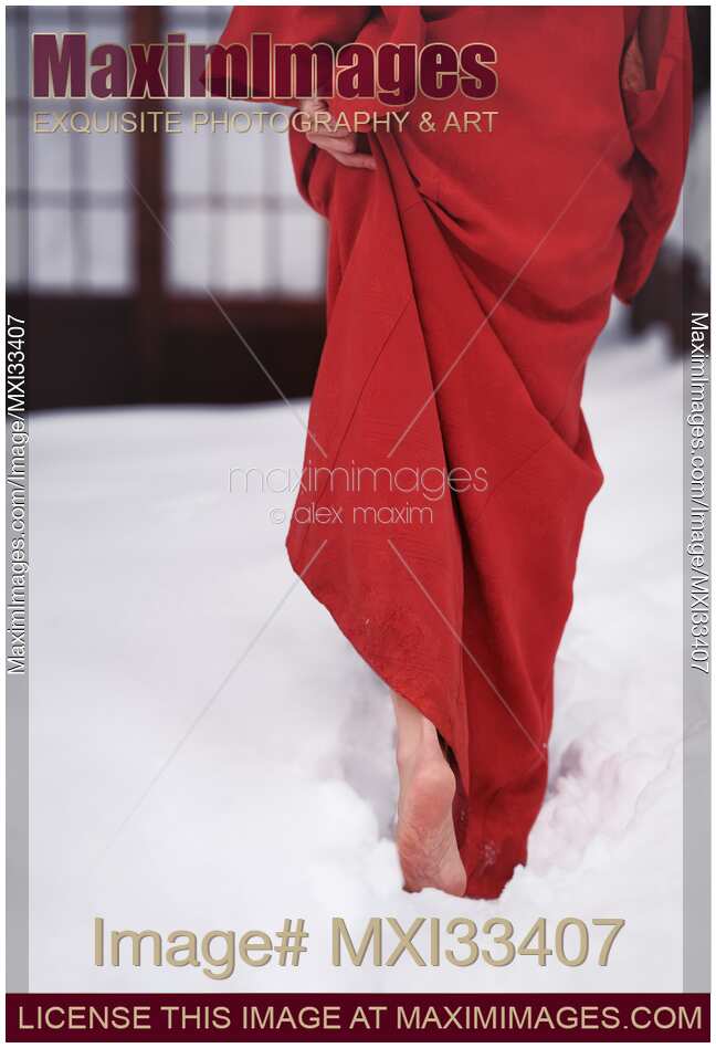Woman in red kimono walking barefoot in deep white snow towards traditional Japanese house